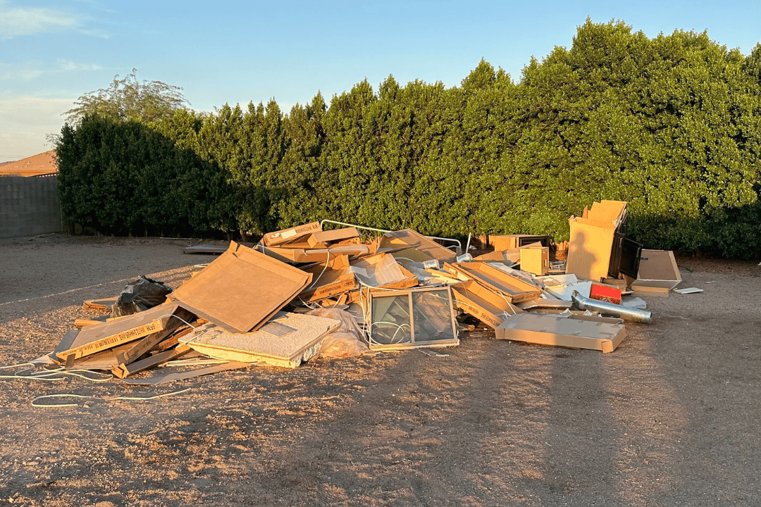 picture before light construction junk removal service performed in Peoria, AZ of a back yard with light construction and remodel junk and debris piled up